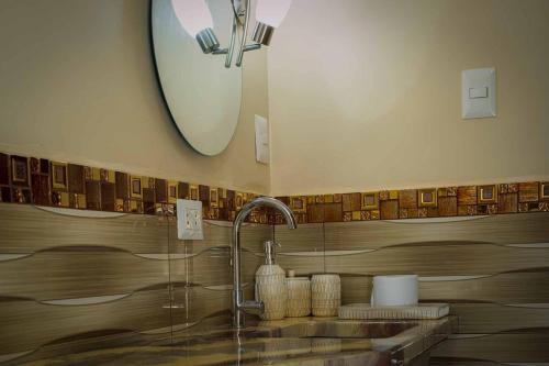 a bathroom with a sink and a mirror at Puerto Bambú Nature and Relaxation in Moyobamba