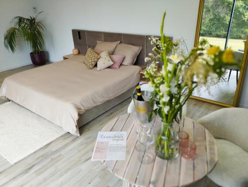 a room with a bed and a table with flowers on it at Il Giardino Segreto in Waterloo