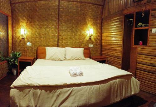 a bedroom with a bed with a stuffed animal on it at Tetebatu flower in Tetebatu