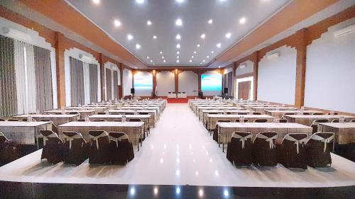 a large room with rows of tables and chairs at Montana Hotel Kuningan in Panawuan