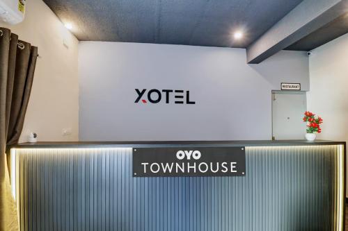 a sign that says yoel and a yoda townhouse at Townhouse Ecity Inn in Bengaluru