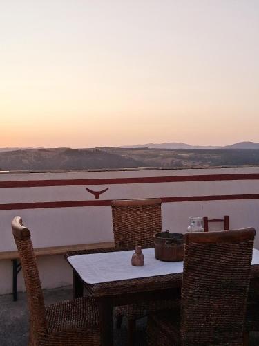 a table with chairs and a teddy bear sitting on top at Nuragic Temple in Esterzili