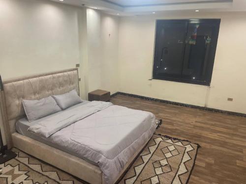 a bedroom with a bed and a window in it at Panoramic Three Bedrooms Apartment in Addis in Addis Ababa