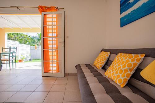 a living room with a couch and an open door at Vaniya in Fonds dʼ Or