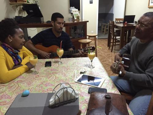 a group of three people sitting around a table with wine glasses at Hotel Cruz Grande-Brava in Vila Nova Sintra