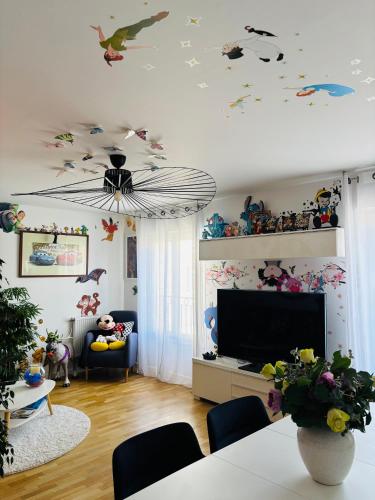 a living room with a ceiling with birds and butterflies at THE ENCHANTED HOUSE ( 15 min walk to Disney) in Serris
