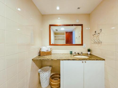a bathroom with a sink and a mirror at Beira Mar Ondina in Salvador