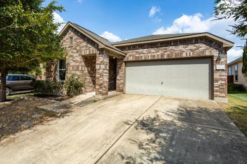 a brick house with a garage at Relaxing 3BR Austin stay with BBQ & Backyard in Austin
