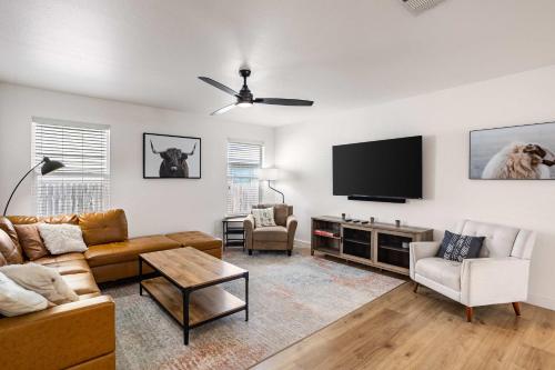 a living room with a couch and a flat screen tv at Relaxing 3BR Austin stay with BBQ & Backyard in Austin