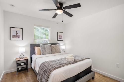 a bedroom with a bed with a ceiling fan at Relaxing 3BR Austin stay with BBQ & Backyard in Austin