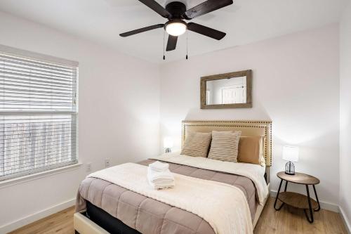 a bedroom with a bed with a ceiling fan at Relaxing 3BR Austin stay with BBQ & Backyard in Austin