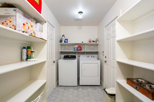 a white laundry room with a washer and dryer at Relaxing 3BR Austin stay with BBQ & Backyard in Austin