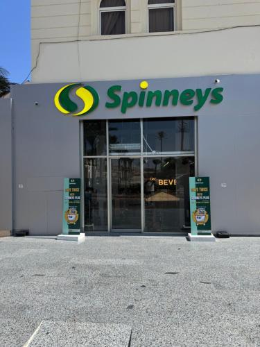 a spinners store front with signs in front of it at Apartment with private Beach in Sahl Hasheesh in Hurghada