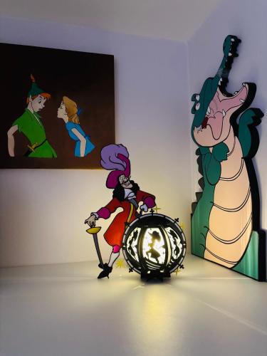 a person riding a scooter in front of a painting at THE ENCHANTED HOUSE ( 15 min walk to Disney) in Serris