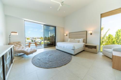 a bedroom with a bed and a living room at South Bank in Long Bay Hills