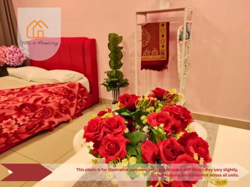 a room with a table with a bouquet of red roses at RumaKU at Cybersquare SOHO Cyberjaya - Studio - Wifi in Cyberjaya