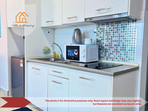 a white kitchen with a microwave and a sink at RumaKU at Cybersquare SOHO Cyberjaya - Studio - Wifi in Cyberjaya