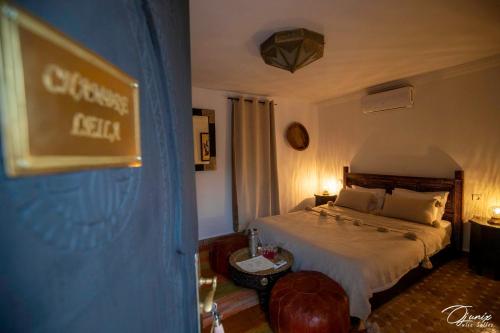 a hotel room with a bed and a sign on the wall at Riad Zoraida in Marrakech
