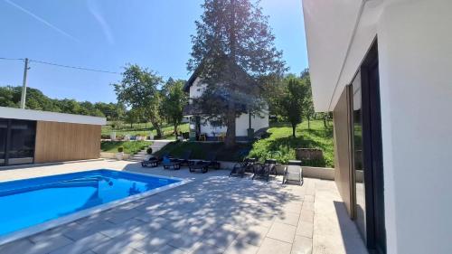 a swimming pool in the backyard of a house at Daisy2 in Banja Luka
