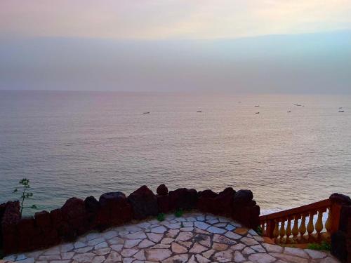 a view of the ocean from behind a fence at Toubab Dialaw Gareye in Rufisque