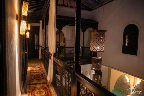 a hallway of a house with a staircase with a rug at Riad Zoraida in Marrakech