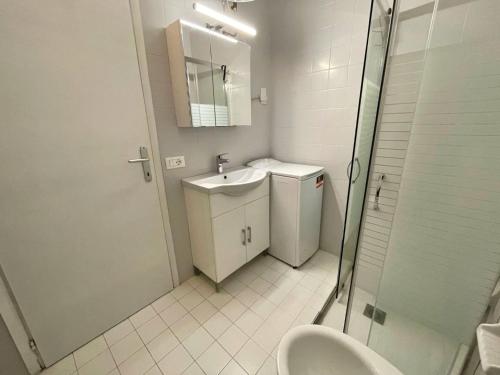 a bathroom with a toilet and a sink and a shower at Flat with shared pool-Beahost in Porto Santa Margherita di Caorle