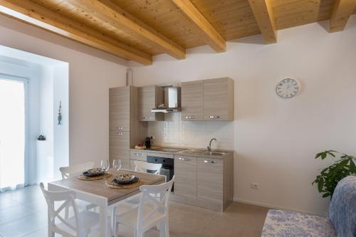 a kitchen and dining room with a table and chairs at Dimora Caprera - Appartamenti in Falconara Marittima