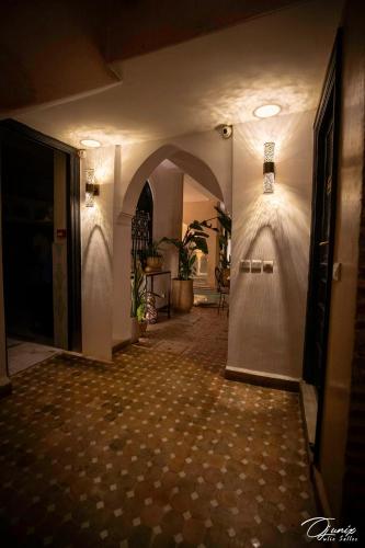 a hallway of a building with a door and a tile floor at Riad Zoraida in Marrakech