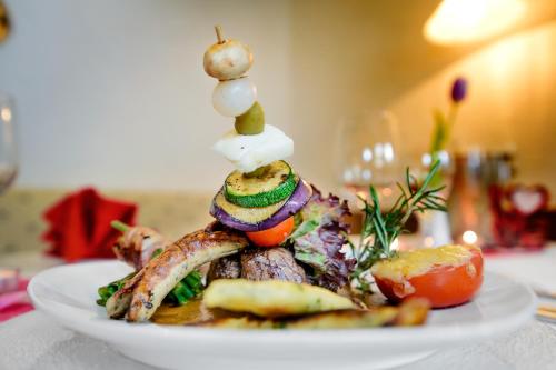 a plate of food with vegetables on a table at Holzschuhs Schwarzwaldhotel in Baiersbronn