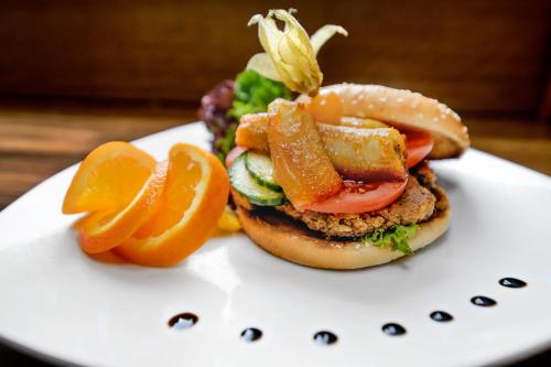 a sandwich with carrots and tomatoes on a white plate at Holzschuhs Schwarzwaldhotel in Baiersbronn
