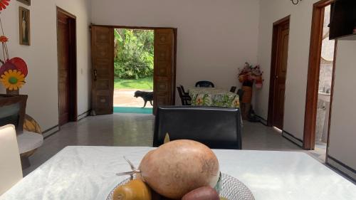a table with a bowl of fruit on top of it at habitaciones ecopolis en el queremal in El Queremal