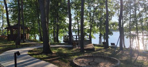 a park with a playground and a gazebo near the water at Apartament Ukiel by Rent4You in Olsztyn