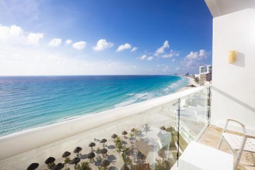 a balcony with a view of the ocean at Krystal Cancun in Cancún