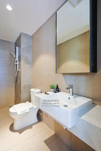 a bathroom with a white sink and a toilet at Paxtonz Suites by Wodages in Petaling Jaya