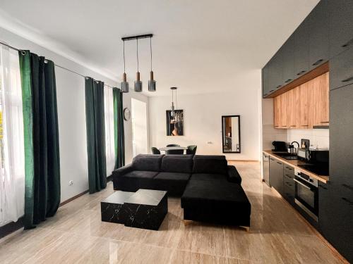 a living room with a couch and a table at Apartament Szmaragdowy nad Rzeką in Wągrowiec