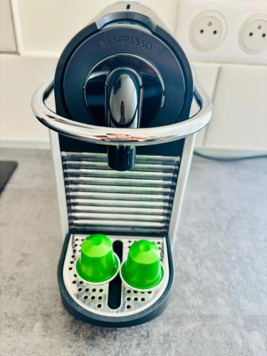 a kitchenaid mixer sitting on a counter with green bowls at Arbre de Vie in Amnéville