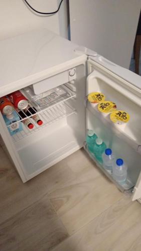 an open refrigerator with drinks and water bottles in it at L'Aurora Porto Torres in Porto Torres