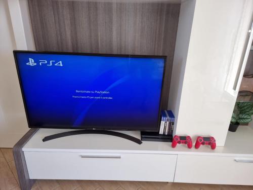 a flat screen tv sitting on top of a white cabinet at Charme House Trulli, Bari, Polignano, Monopoli 5 star in Turi