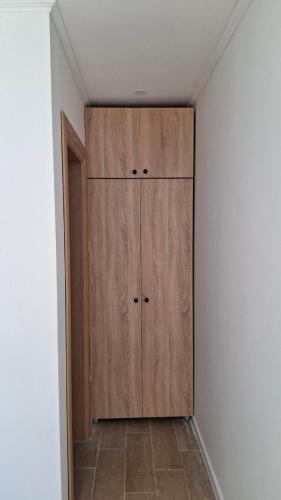 a closet with a wooden cabinet in a room at Daisy3 in Banja Luka