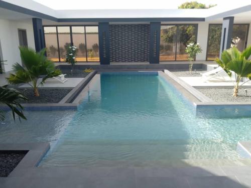 a swimming pool in the middle of a house at Luxurious 4 bedroom Villa next to the lagoon in Somone