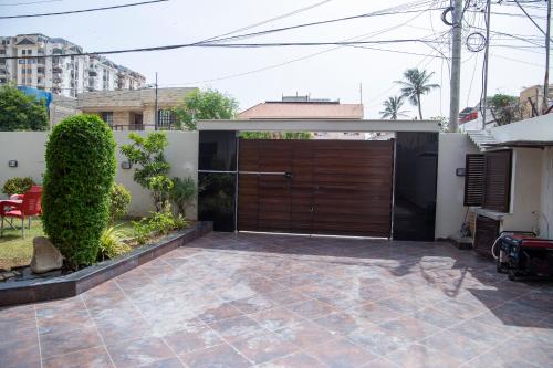 a garage with a large wooden garage door at The Red Tree II Executive Guest House in Karachi