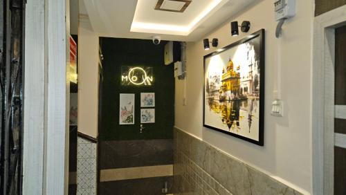 a hallway with a sign that says mom on the wall at Hotel Prince B in Guwahati