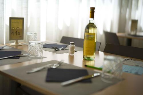 a bottle of wine sitting on top of a table at Hotel Sant'Elena in Rimini