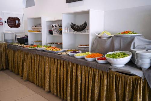 a buffet with many bowls of food on a table at Hotel Sant'Elena in Rimini