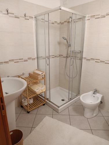 a bathroom with a shower and a toilet and a sink at La Tour in Oyace