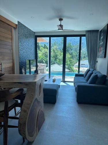 a living room with a couch and a table at Villa Thai Sabai 2, Lamai in Lamai