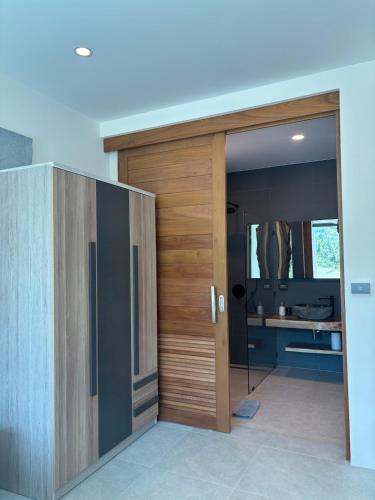 a wooden door in a room with a desk at Villa Thai Sabai 2, Lamai in Lamai