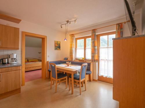 a kitchen and dining room with a table and chairs at Apart Romantica in Pfunds