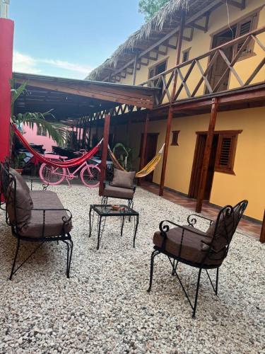 a group of chairs sitting outside of a building at Hotel Loro Tuerto in Santa Cruz de Barahona