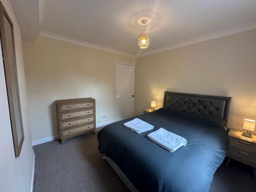 a bedroom with a bed with two towels on it at Ely Stays Flat 2 City Center in Ely